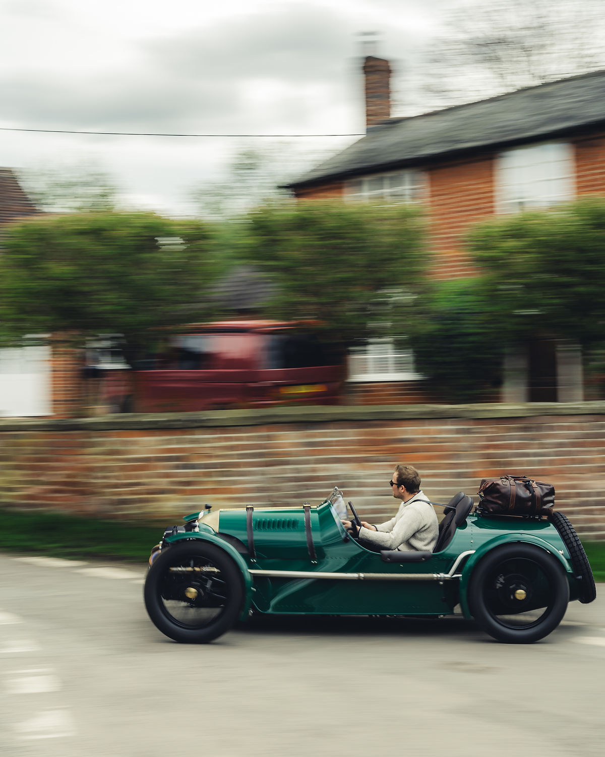 Fast pan shot of a sports car driving with luggage, Pembleton T24